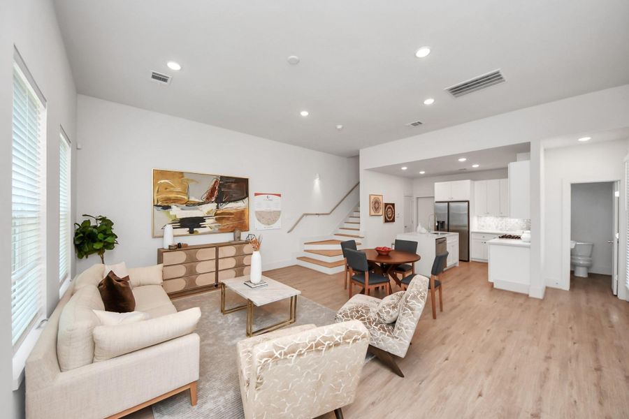 Open-concept living area that flows into the dining and kitchen. Open-concept living area that flows into the dining and kitchen.