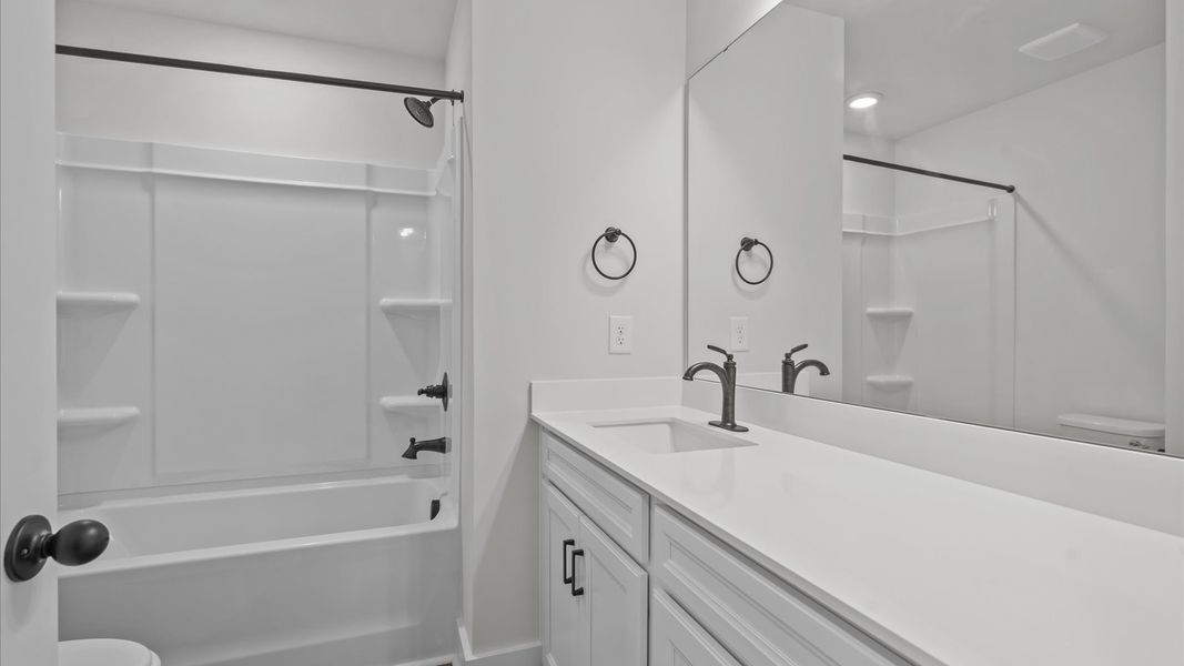 Vibrant and welcoming bathroom with elegant countertop space and polished details