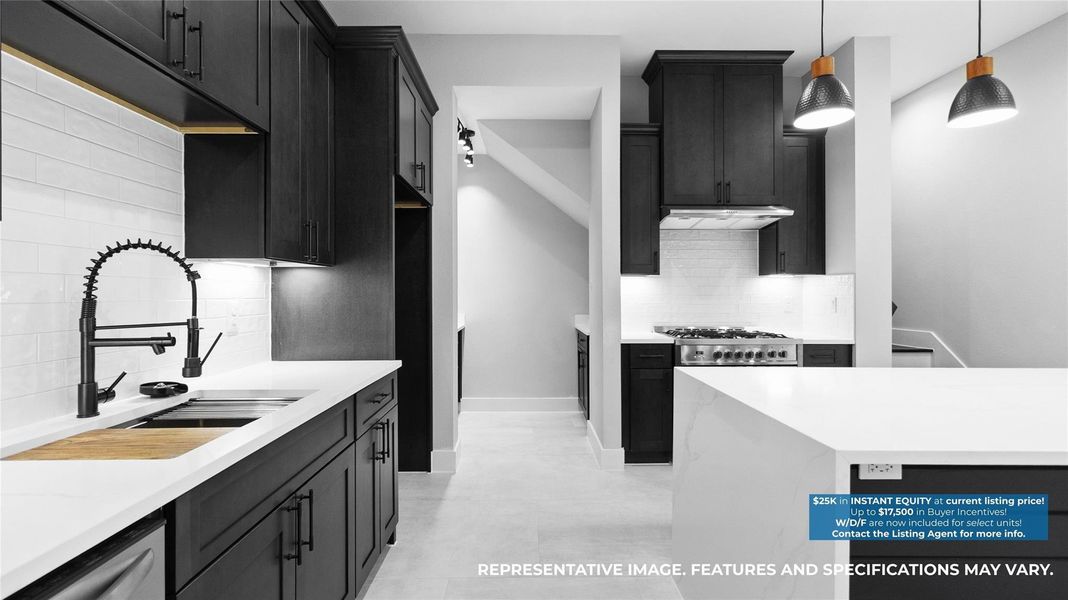 Cooking feels effortless with the sleek navy cabinetry, gold fixtures, and plenty of counter space to spread out and create. Cooking feels effortless with the sleek navy cabinetry, gold fixtures, and plenty of counter space to spread out and create.