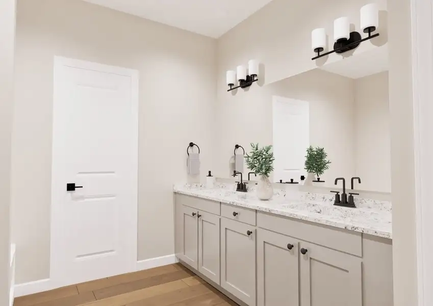 Modern bathroom with light beige walls, a double sink vanity with marble countertop, and two mirrors. Warm lighting and greenery create a serene atmosphere.