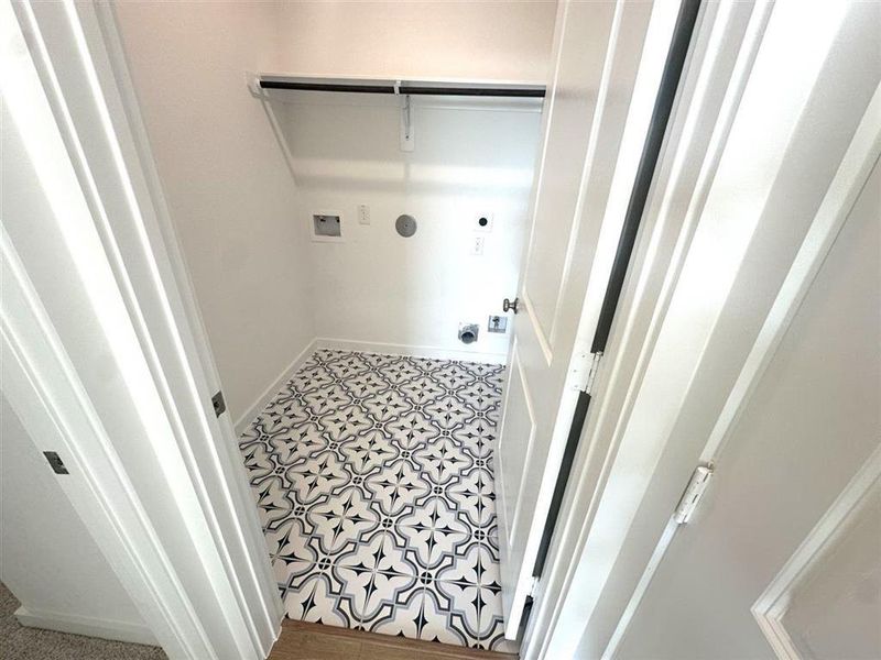 Utility room also has fun tile accent to stand out from standards.