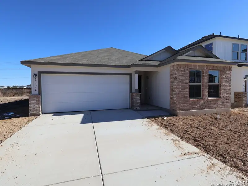 Front exterior of a new home in Agave, San Antonio, TX, highlighting curb appeal (Image 1).
