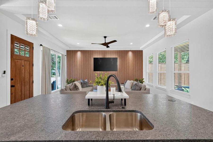 Spacious kitchen island featuring a dual stainless steel sink and a matte black faucet