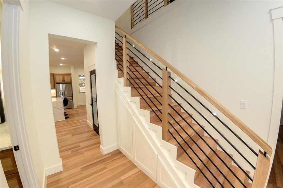 Stairway featuring hidden storage and AV rack.