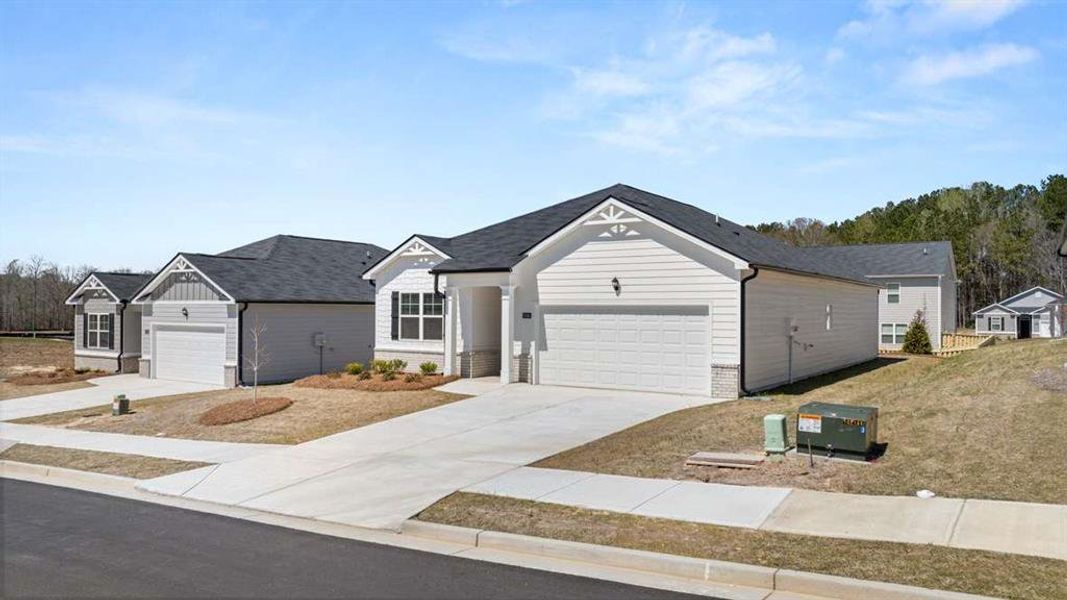 Front exterior of a new home in Champion's Run, Lithonia, GA, highlighting curb appeal (Image 1).