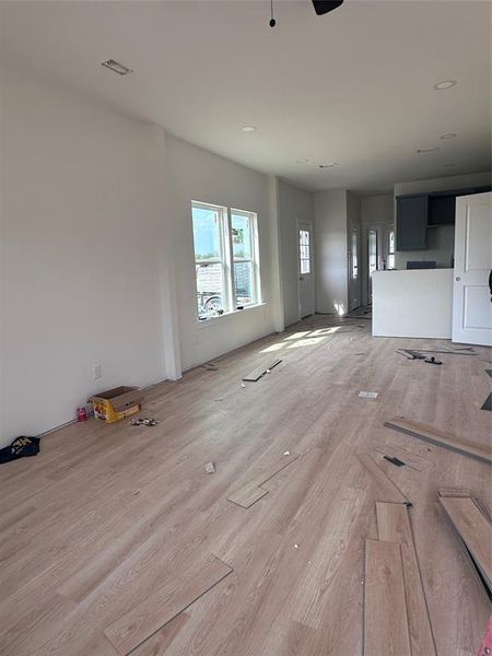 Unfurnished living room featuring wood finished floors and ceiling fan Unfurnished living room featuring wood finished floors and ceiling fan