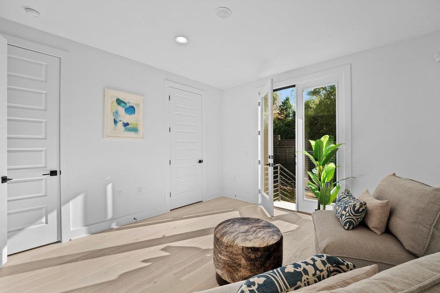 Living area featuring wood finished floors and recessed lighting Living area featuring wood finished floors and recessed lighting