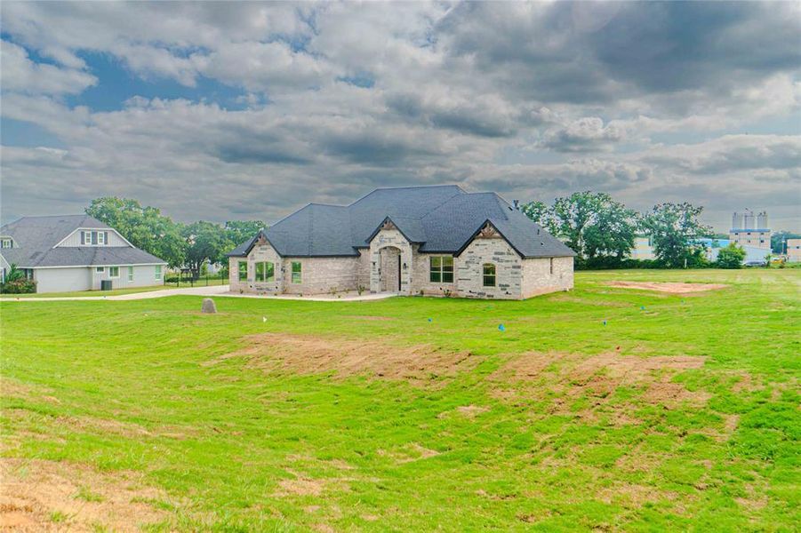 French provincial home featuring a front lawn