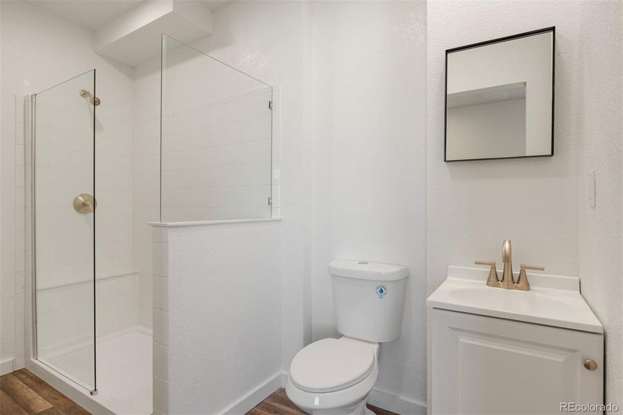 Features a walk-in shower with white tile and clean, modern finishes.
