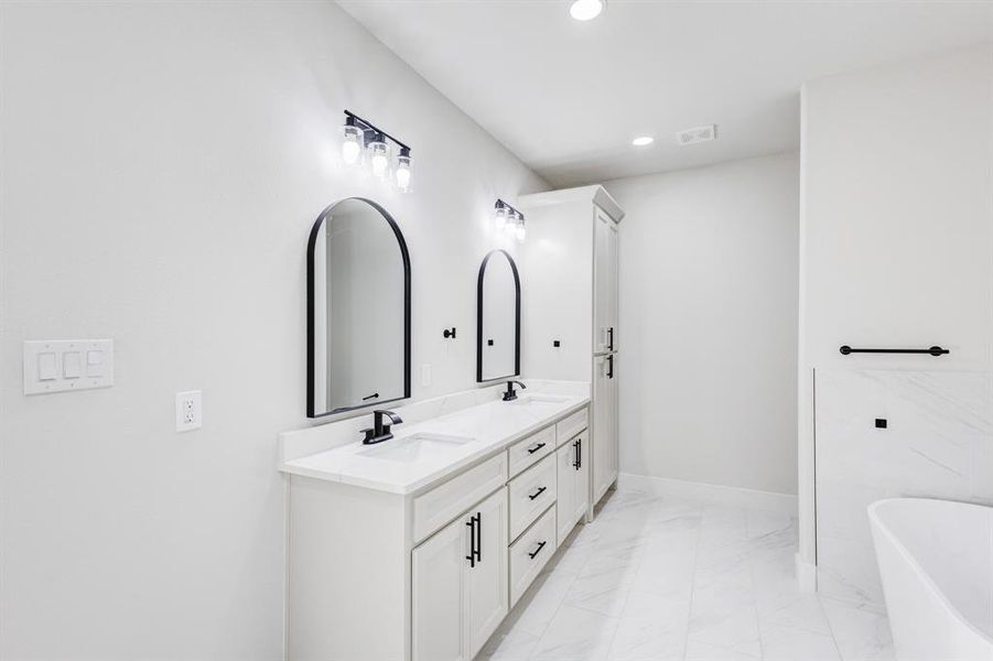 Bathroom with a washtub and vanity