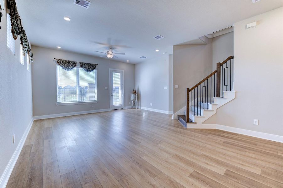 Open-concept living area with wood-look flooring, natural light, and seamless flow for everyday living.