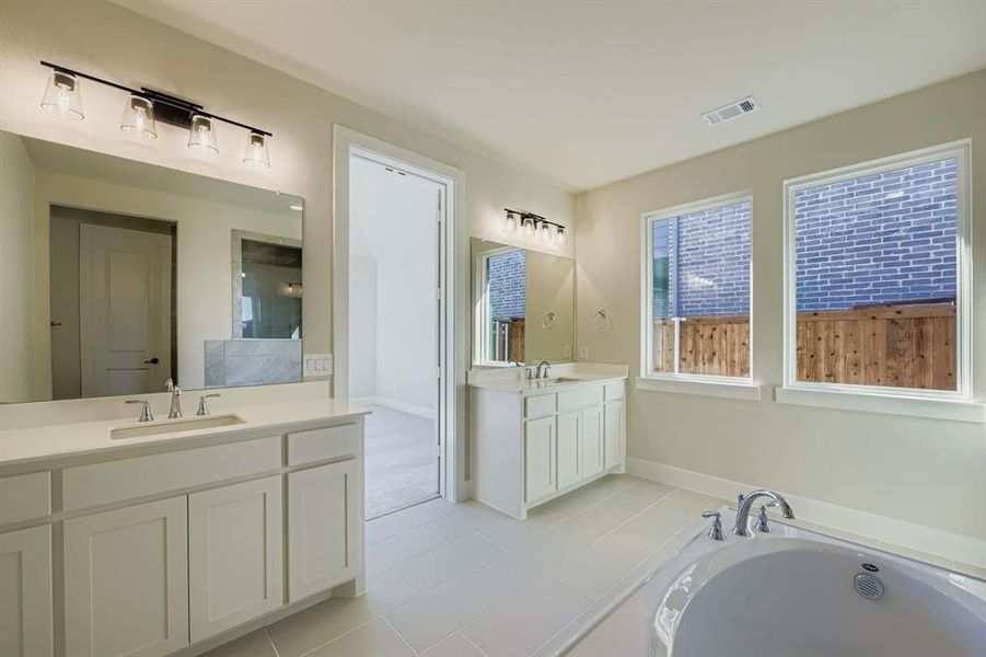 Bathroom with two vanities, a bath, light tile patterned floors, and a shower Bathroom with two vanities, a bath, light tile patterned floors, and a shower
