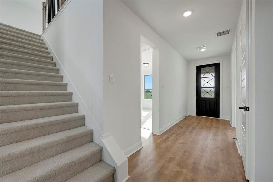 Entryway featuring light wood-style floors and recessed lighting