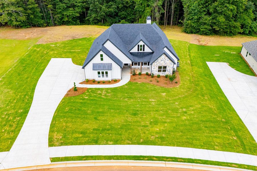 Front exterior of a new home in WOODMONT RESERVE, Roopville, GA, highlighting curb appeal (Image 44).