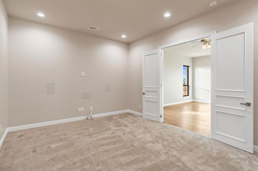 Unfurnished room featuring ceiling fan and light carpet