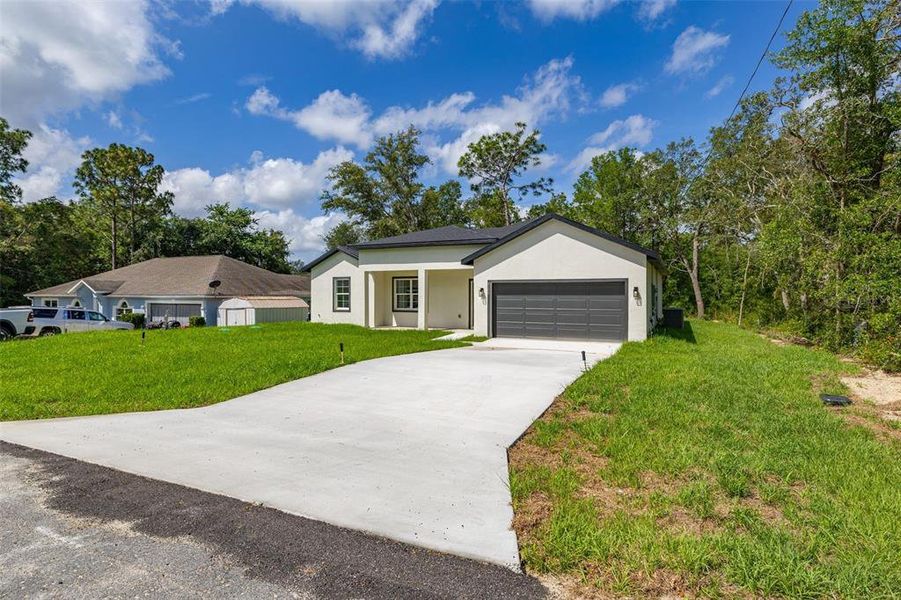 Front exterior of a new home in , Dunnellon, FL, highlighting curb appeal (Image 24).