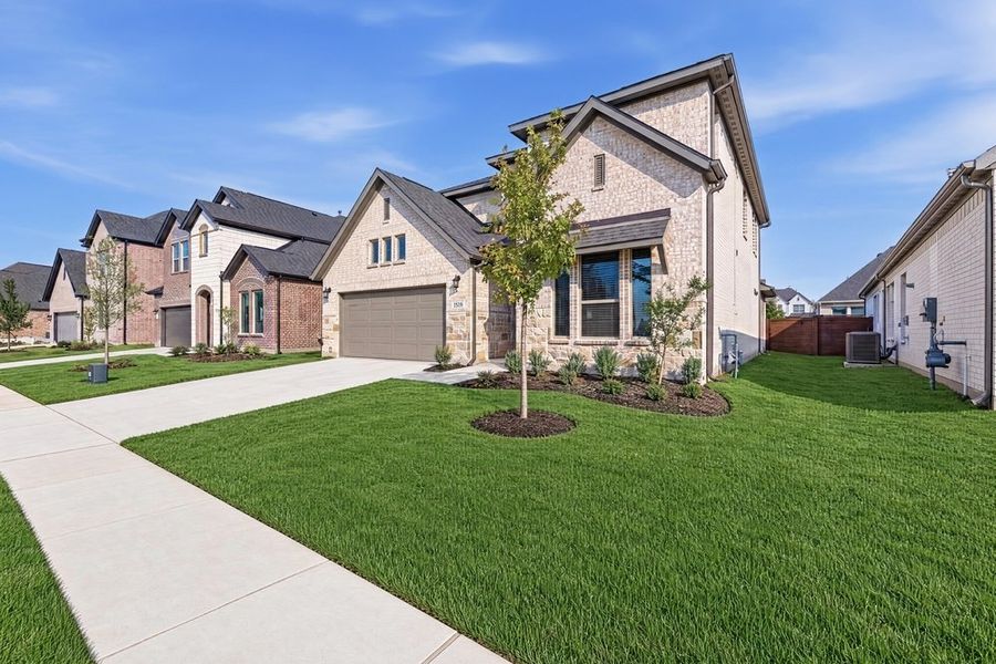 Front exterior of a new home in The Ridge at Northlake, Northlake, TX, highlighting curb appeal (Image 19). Front exterior of a new home in The Ridge at Northlake, Northlake, TX, highlighting curb appeal (Image 19).