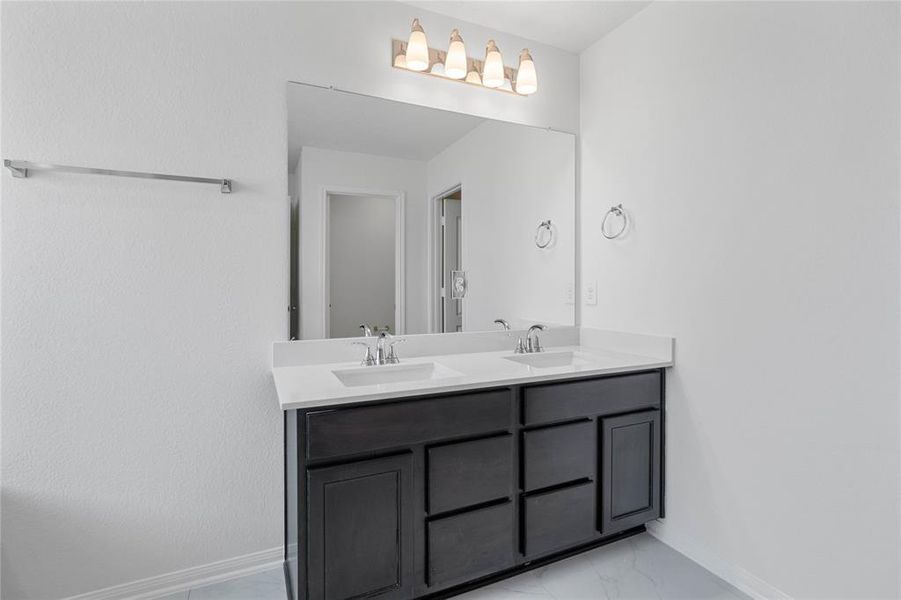 This primary bathroom is definitely move-in ready! Featuring dual vanities, stained cabinets, light countertop, high ceilings, neutral paint, sleek and modern finishes.