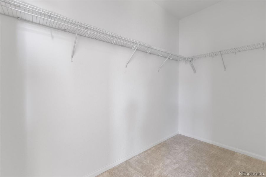 Upper level primary bedroom walk-in closet