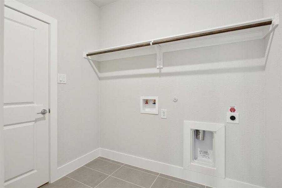 Laundry room featuring gas dryer hookup, washer hookup, tile patterned flooring, and electric dryer hookup