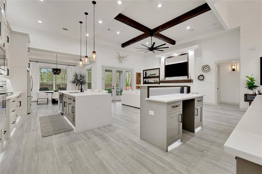 Opposite side view of kitchen, entertainment area, dining room and family room. This home flows very well! Double glass doors lead to the outside covered patio and fireplace area.