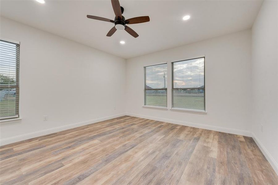 Spare room featuring light hardwood / wood-style floors and ceiling fan