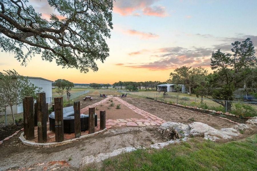 Take in the sunset and Hill Country breeze from your expansive backyard retreat. With scenic views, native landscaping, and multiple gathering areas, this outdoor space is designed for peaceful moments and unforgettable evenings near Canyon Lake.