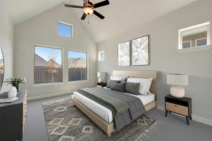 Carpeted bedroom featuring a high ceiling and ceiling fan