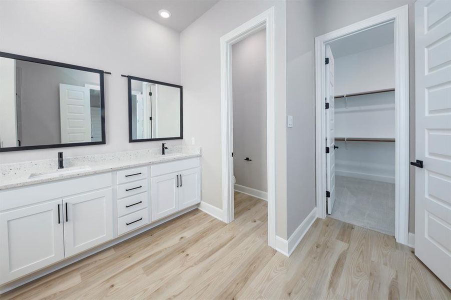 Double sinks and beautiful countertops add to the tranquility of this spa like bathroom.