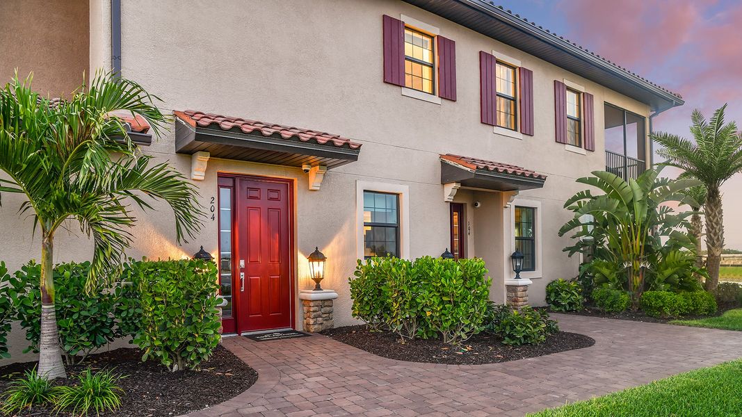 Front exterior of a new home in Esplanade by the Islands Coach Homes, Naples, FL, highlighting curb appeal (Image 2).