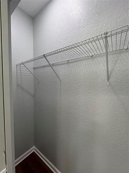 Spacious closet featuring dark wood-style flooring Spacious closet featuring dark wood-style flooring