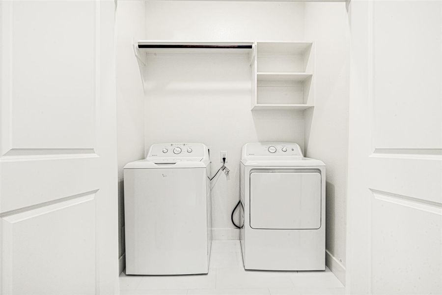 Laundry room is conveniently located on the second floor designed for everyday functionality.