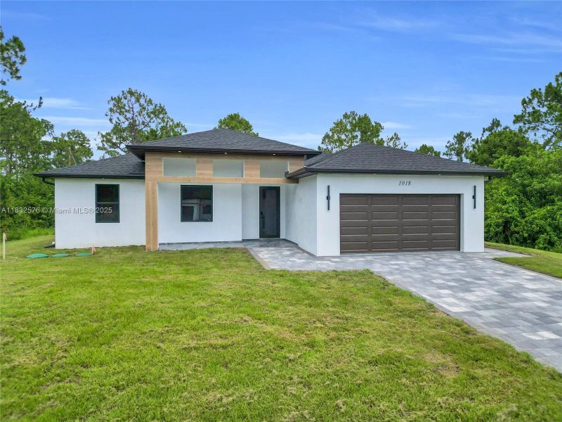Front exterior of a new home in , Lehigh Acres, FL, highlighting curb appeal (Image 29).