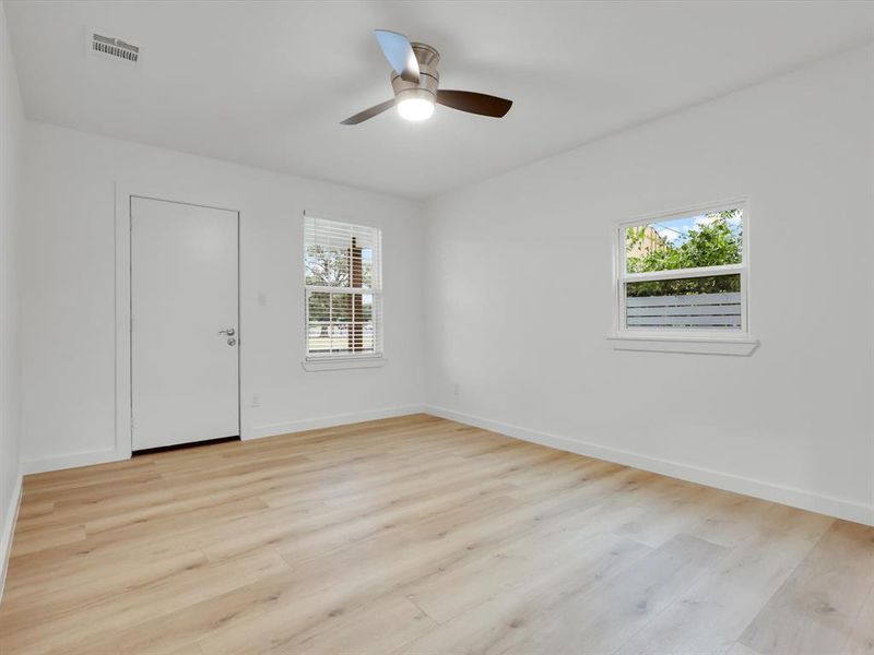 Spare room featuring ceiling fan and light hardwood / wood-style floors