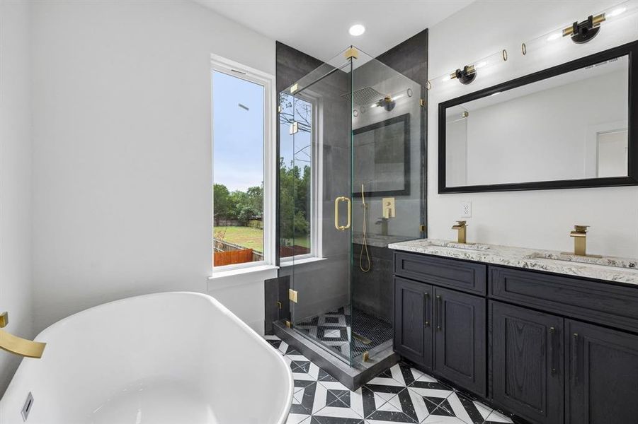 Freestanding soaking tub with gold-finish fixtures Freestanding soaking tub with gold-finish fixtures