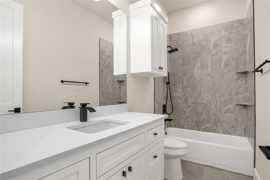Bathroom featuring vanity, shower / bath combination, and tile patterned flooring Bathroom featuring vanity, shower / bath combination, and tile patterned flooring