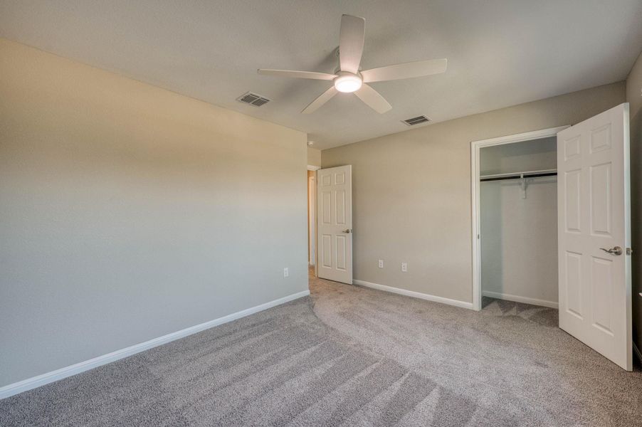 Plush carpeting underfoot warms this secondary bedroom complete with a built-in closet. Plush carpeting underfoot warms this secondary bedroom complete with a built-in closet.