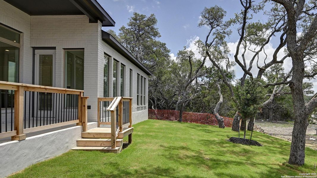 Front exterior of a new home in Esperanza 60', Boerne, TX, highlighting curb appeal (Image 1).