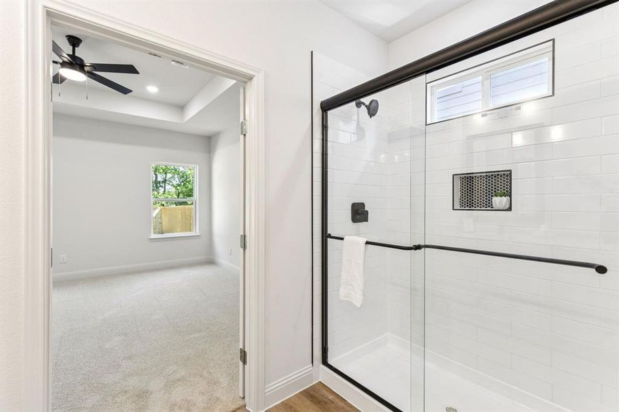 Bathroom with a stall shower, recessed lighting, and ceiling fan