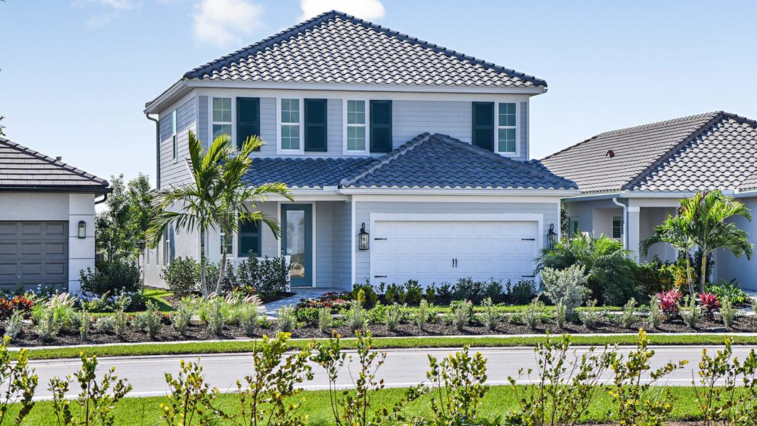 Front exterior of a new home in SkySail Real Estate and Homes for Sale in Naples, FL - Neal Communities, Naples, FL, highlighting curb appeal (Image 2).