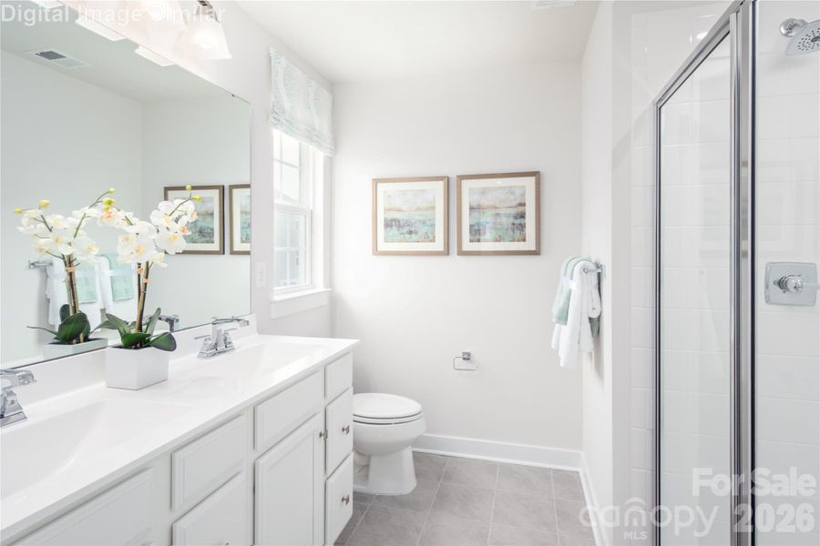 Luxury lives here — with sleek shower doors, dual sinks, and windows that bring in natural light. Luxury lives here — with sleek shower doors, dual sinks, and windows that bring in natural light.