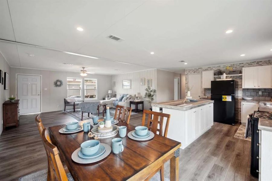 Dining room with hardwood / wood-style floors and ceiling fan