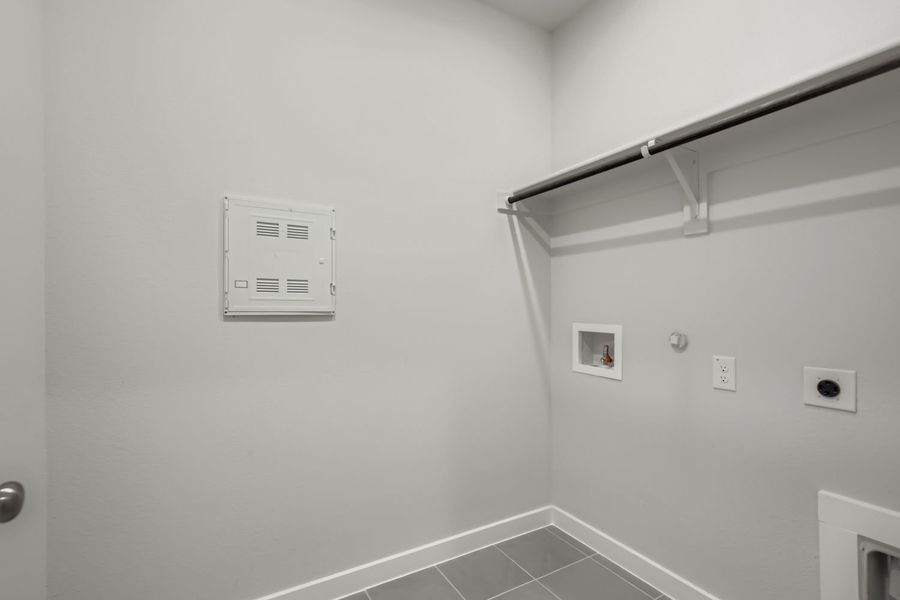 A white wall with a light fixture.