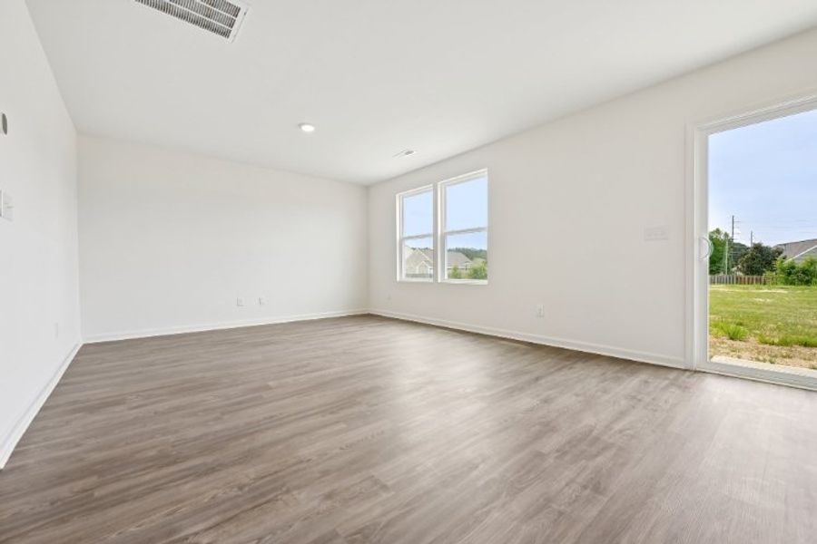 A room with a wood floor and a window.