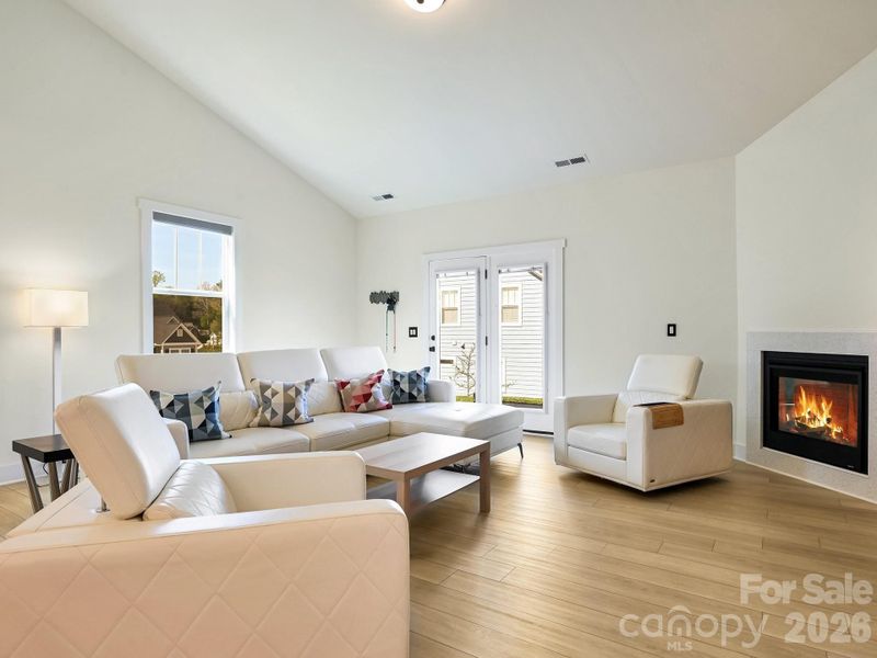 Cozy gas fireplace. Door to rear patio.