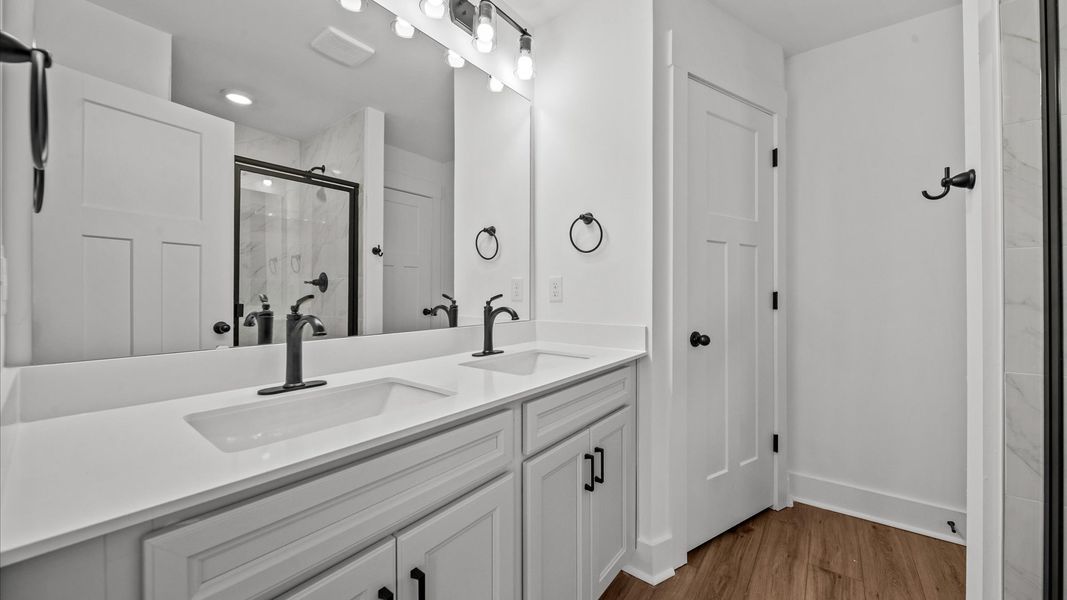 Exceptional en-suite with dual vanity and glass-enclosed walk-in shower for superior everyday comfort at Clayton Crossing