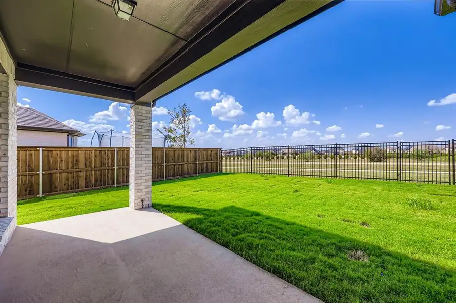 Fenced backyard with a patio area