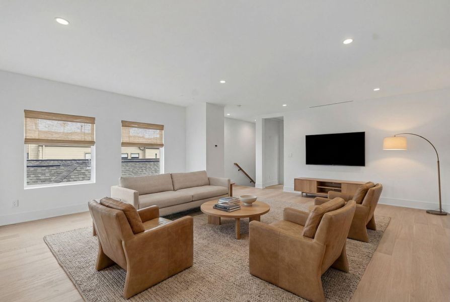 Third level game room with abundance of natural light. *virtually staged