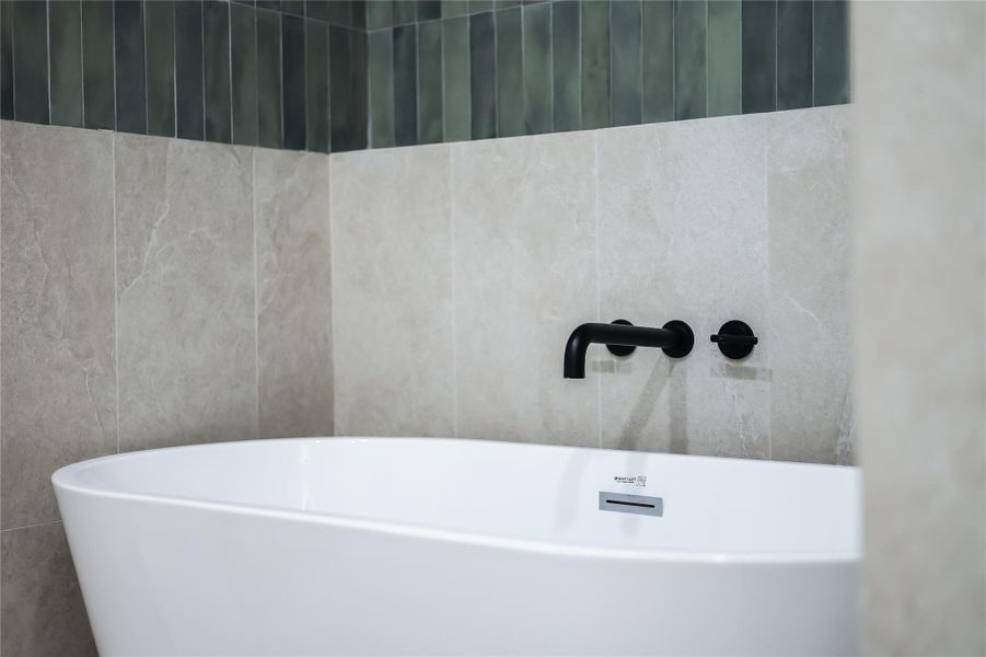 Bathroom with a freestanding tub and tile walls Bathroom with a freestanding tub and tile walls