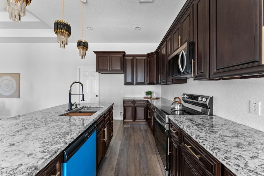 Close-up of the 60" cabinets, hardware, granite pattern, and stainless package—quality finishes throughout. Close-up of the 60" cabinets, hardware, granite pattern, and stainless package—quality finishes throughout.